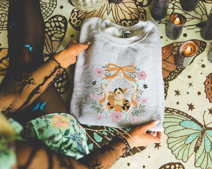 a woman sitting on the floor holding a t - shirt