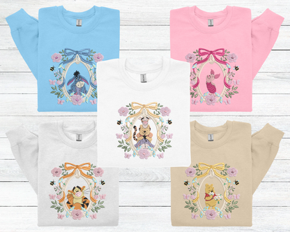 a group of four tshirts with winnie the pooh on them