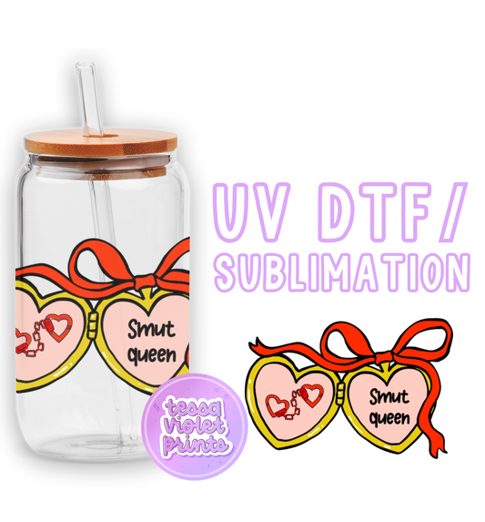 a glass jar with two hearts and a straw