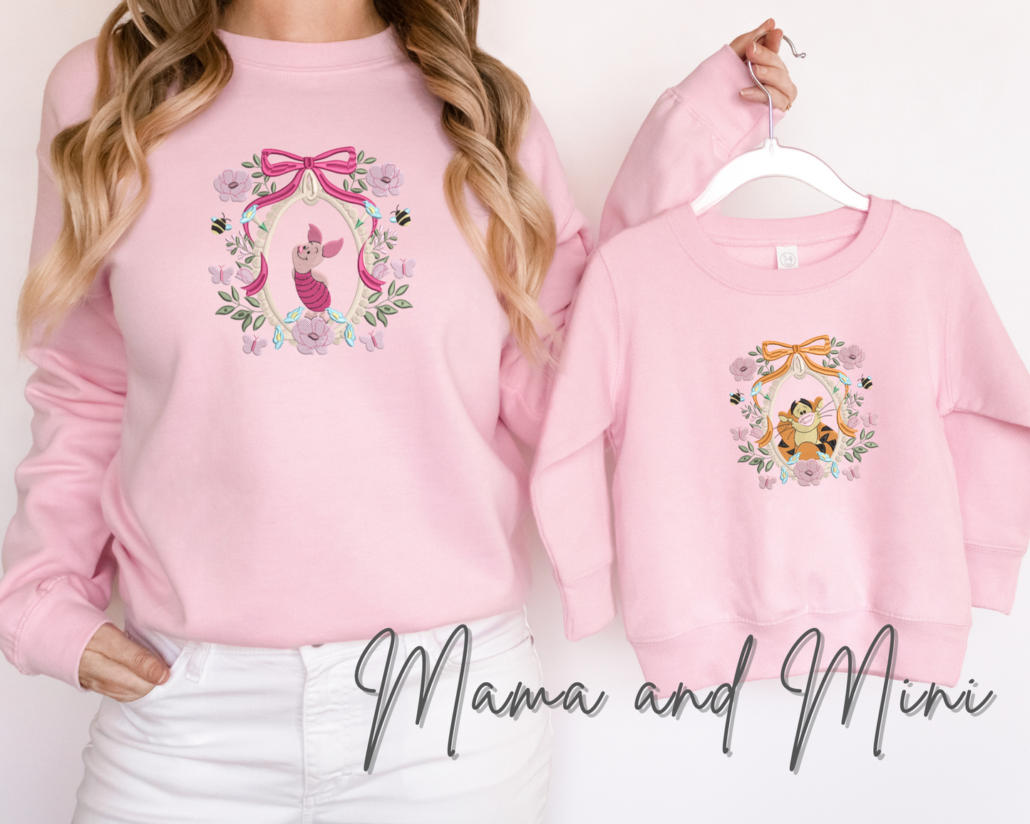 a woman wearing a pink sweatshirt and white jeans